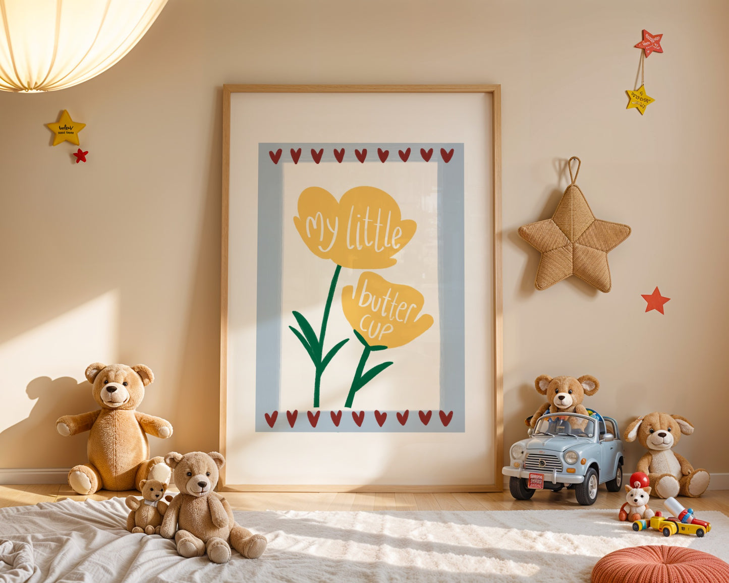 Kids wall print with white background, light blue border and burgundy love hearts top and bottom with an illustration of two yellow buttercups and the words “my little buttercup”.