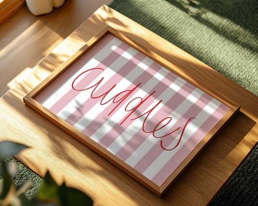 Kids wall art with pink striped background and red ‘cuddles’ text