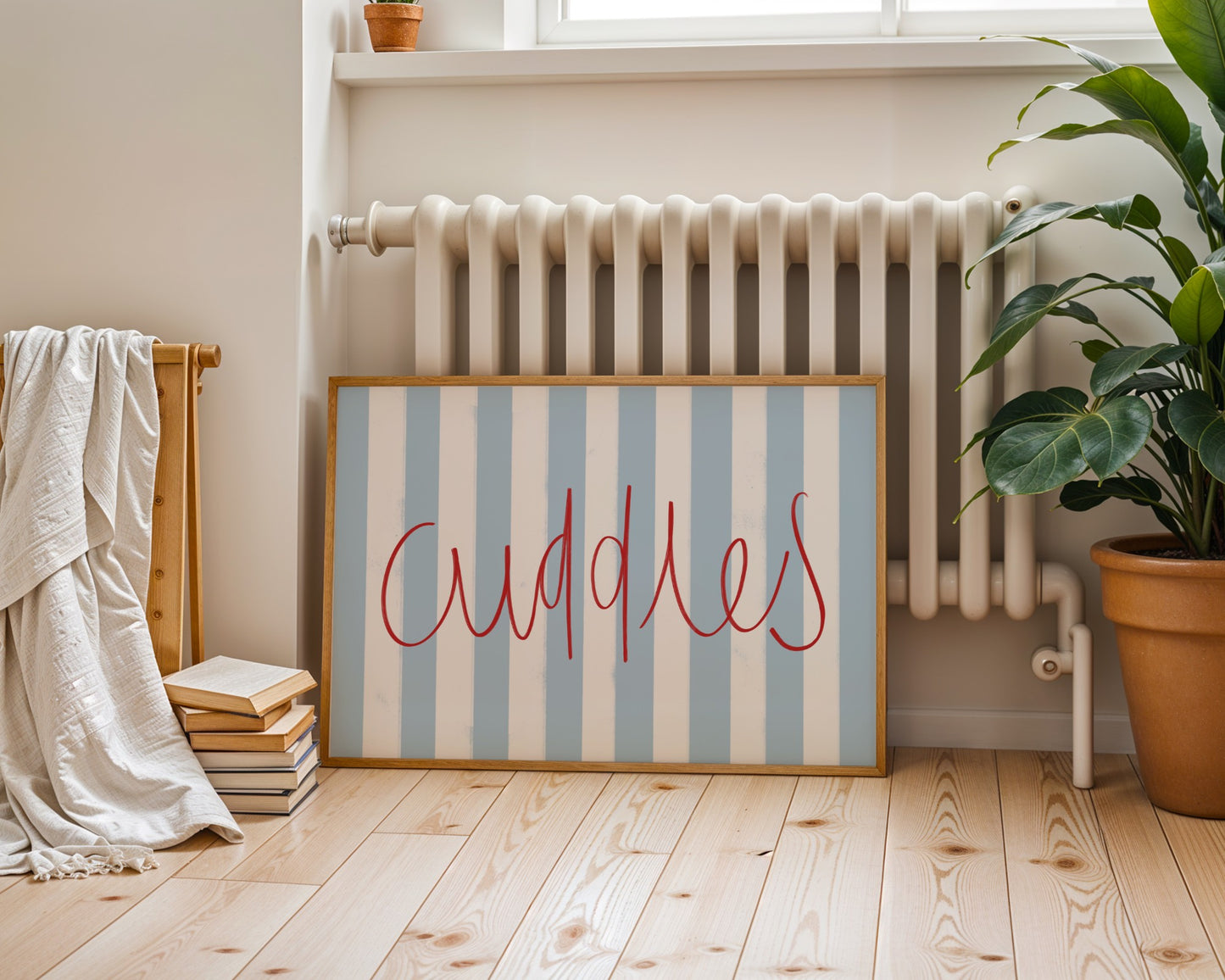 Kids wall art with blue striped background and red ‘Cuddles’ text