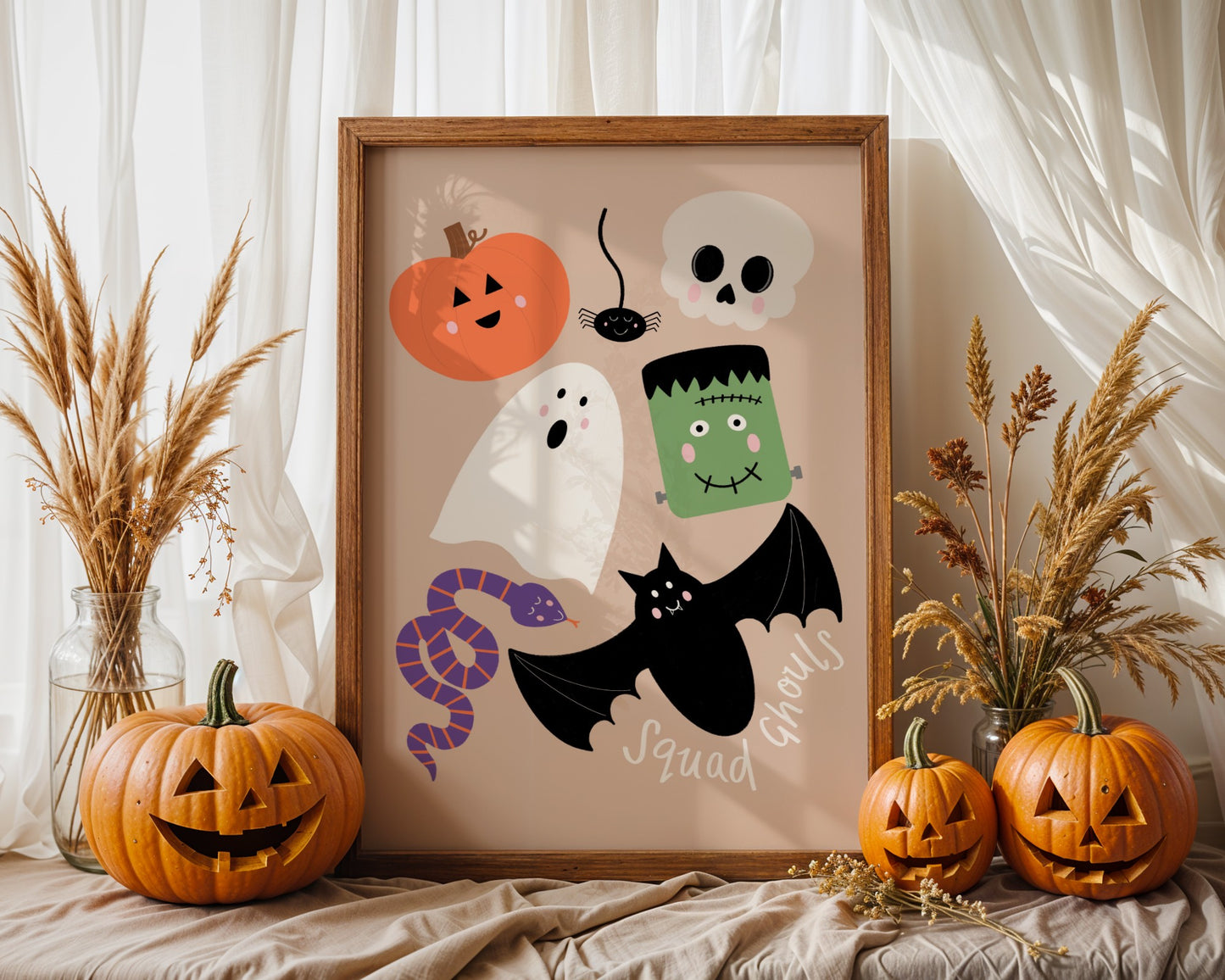 Halloween-themed framed artwork with pumpkins, ghosts, and a Frankenstein monster on a neutral background.