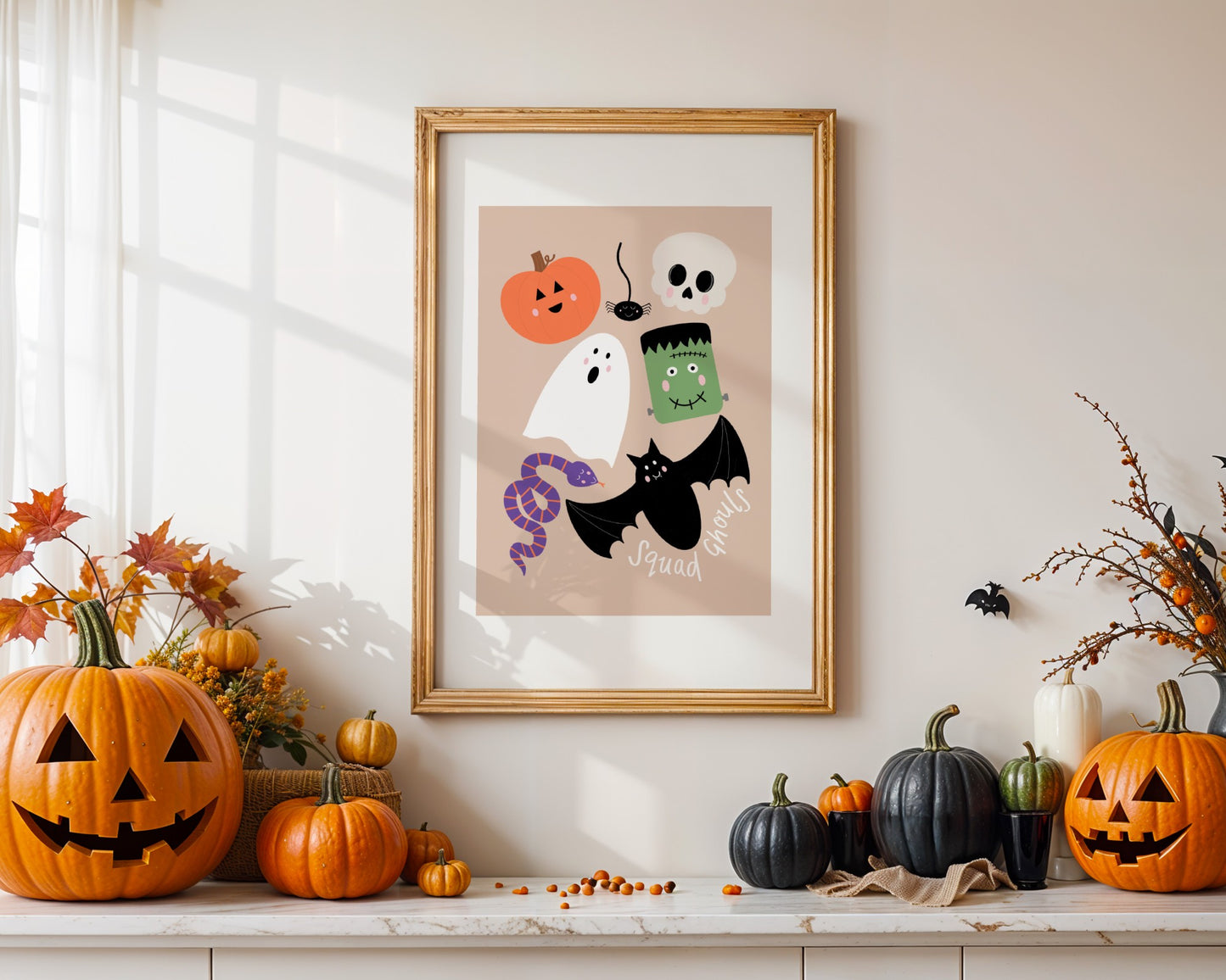 Framed Halloween-themed artwork on a shelf with pumpkins and decorations.