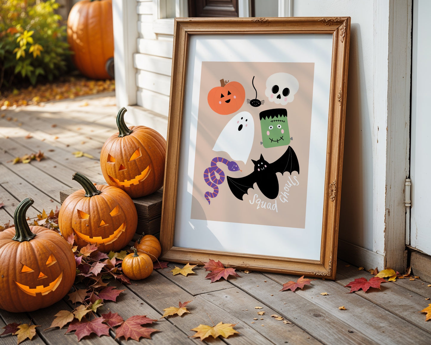 Framed Halloween-themed print with pumpkins on a wooden deck.