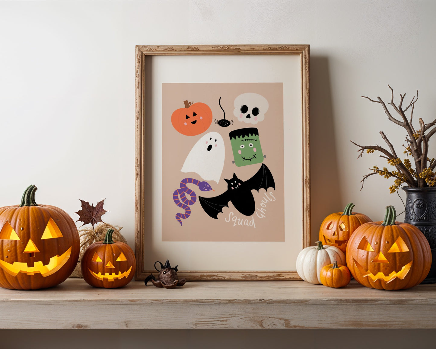 Halloween-themed decorations including pumpkins and a framed print on a shelf.