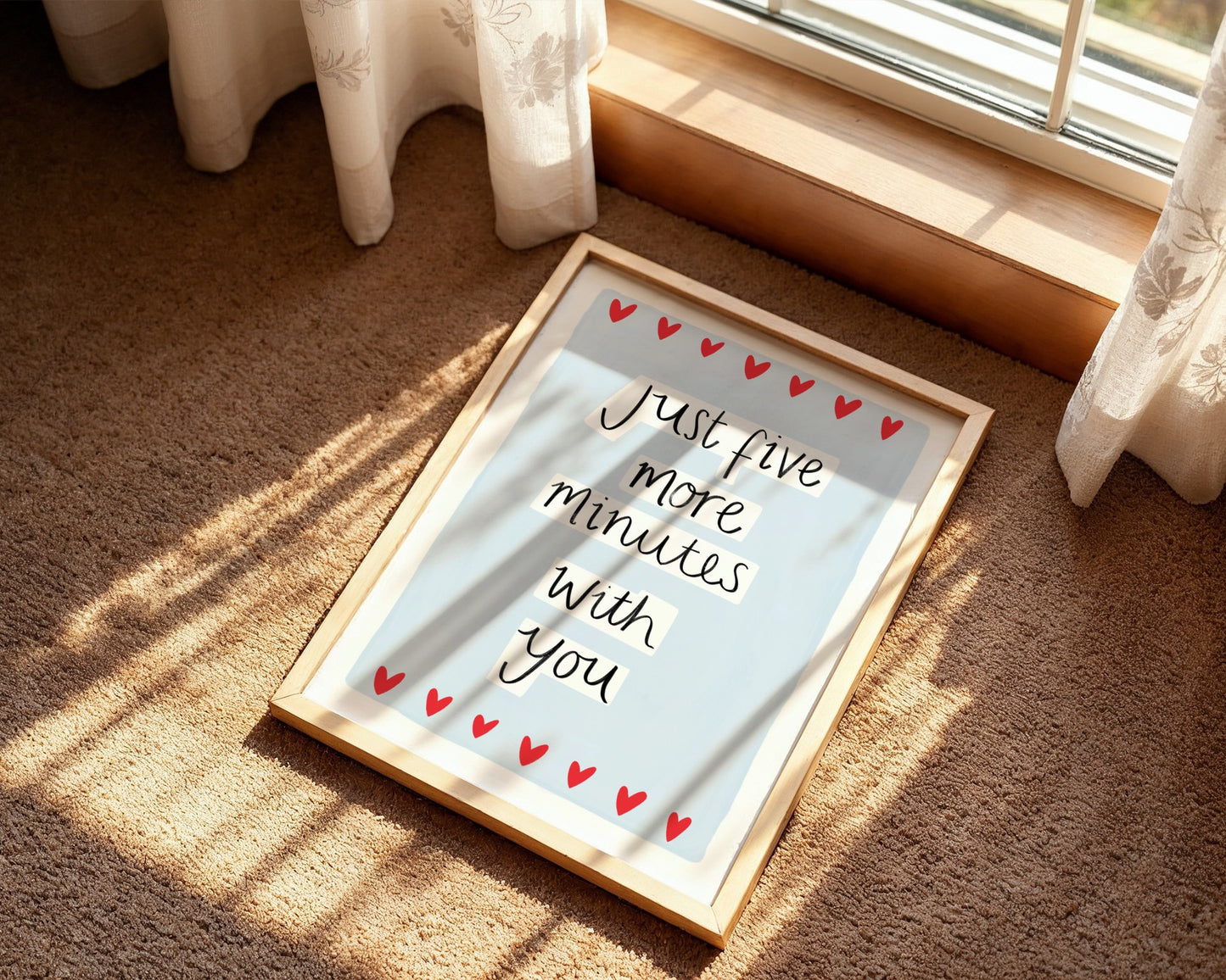 Framed picture with 'Just five more minutes with you' text on a carpeted floor.