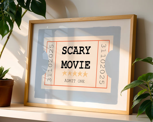 Framed movie ticket-style poster with 'SCARY MOVIE' text on a shelf with plants.