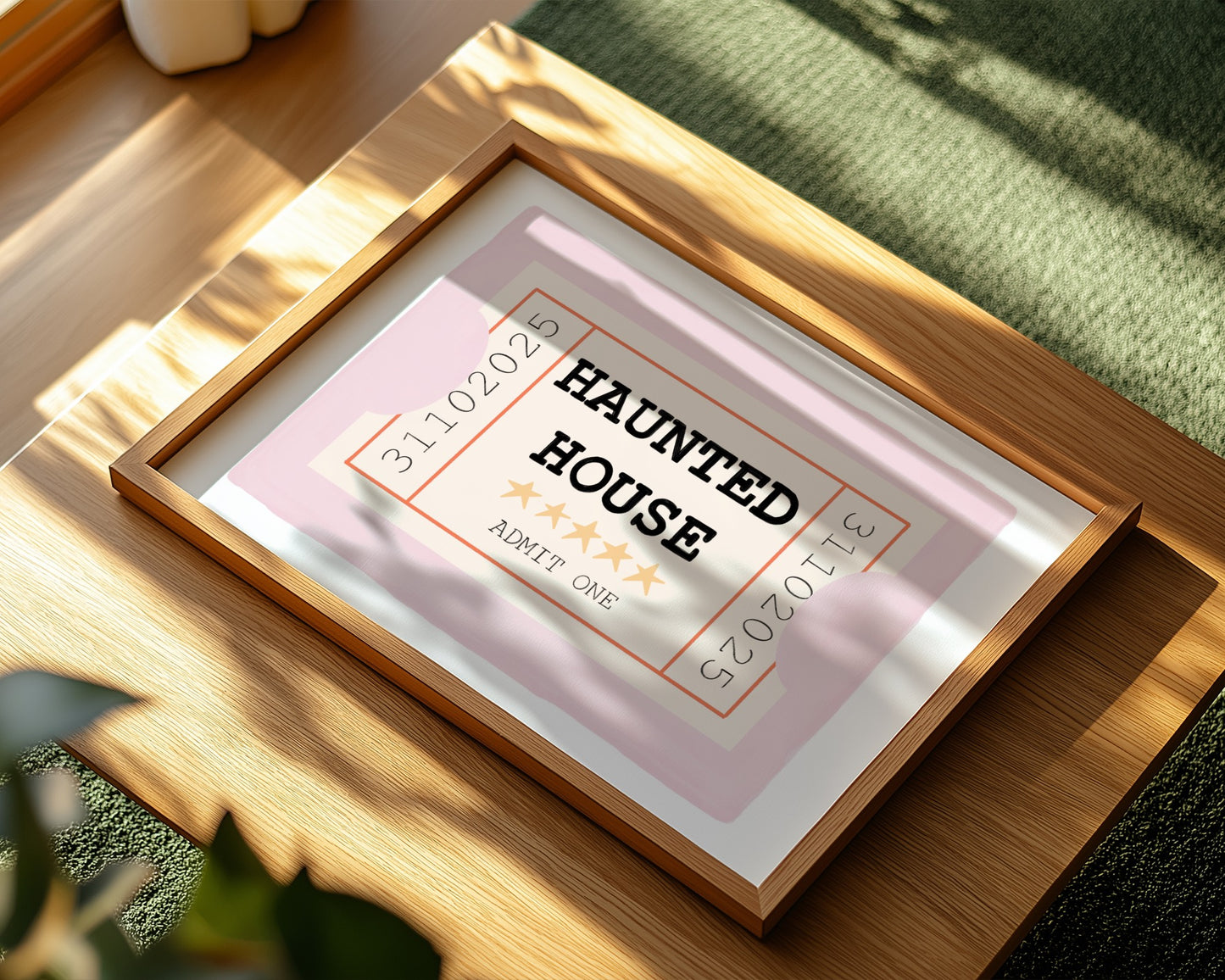 Framed paper with 'Haunted House' text on a wooden surface