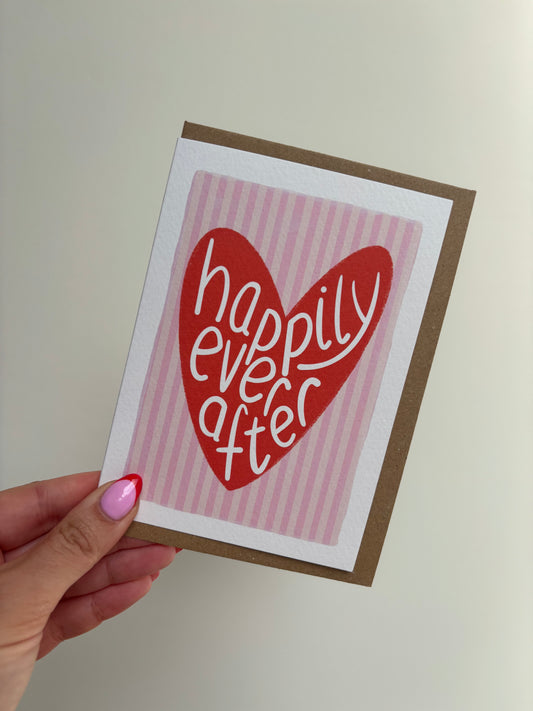 A6 recyclable premium card with white border, Pink striped wedding day card with red love heart with the wording “happily ever after” handwritten inside. Brown Kraft envelop included