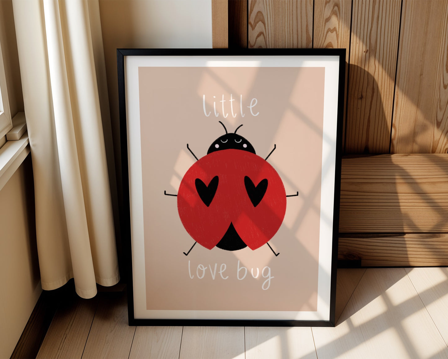 Kids wall art with beige background, a hand drawn illustration of a ladybird with face and the words “little love bug” In white handwritten text.
