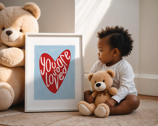 Kids wall art with blue background a red heart illustration featuring “you are so loved” quote