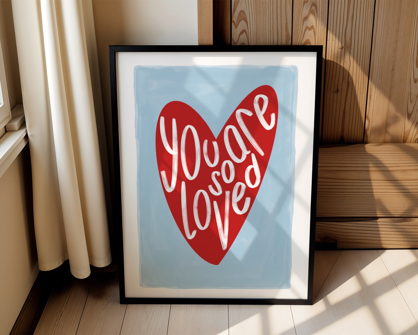 Kids wall art with blue background a red heart illustration featuring “you are so loved” quote