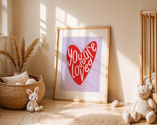 Kids wall art with lilac background a red heart illustration featuring “you are so loved” quote