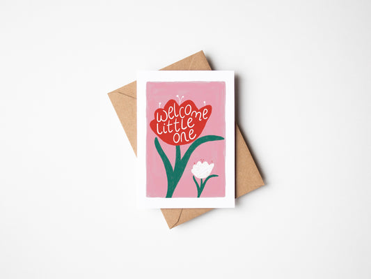 A6 premium textured recyclable card with pink background, and illustration of one large red tulip with the words “welcome little one” sat next to a smaller white tulip. Brown Kraft envelope included.