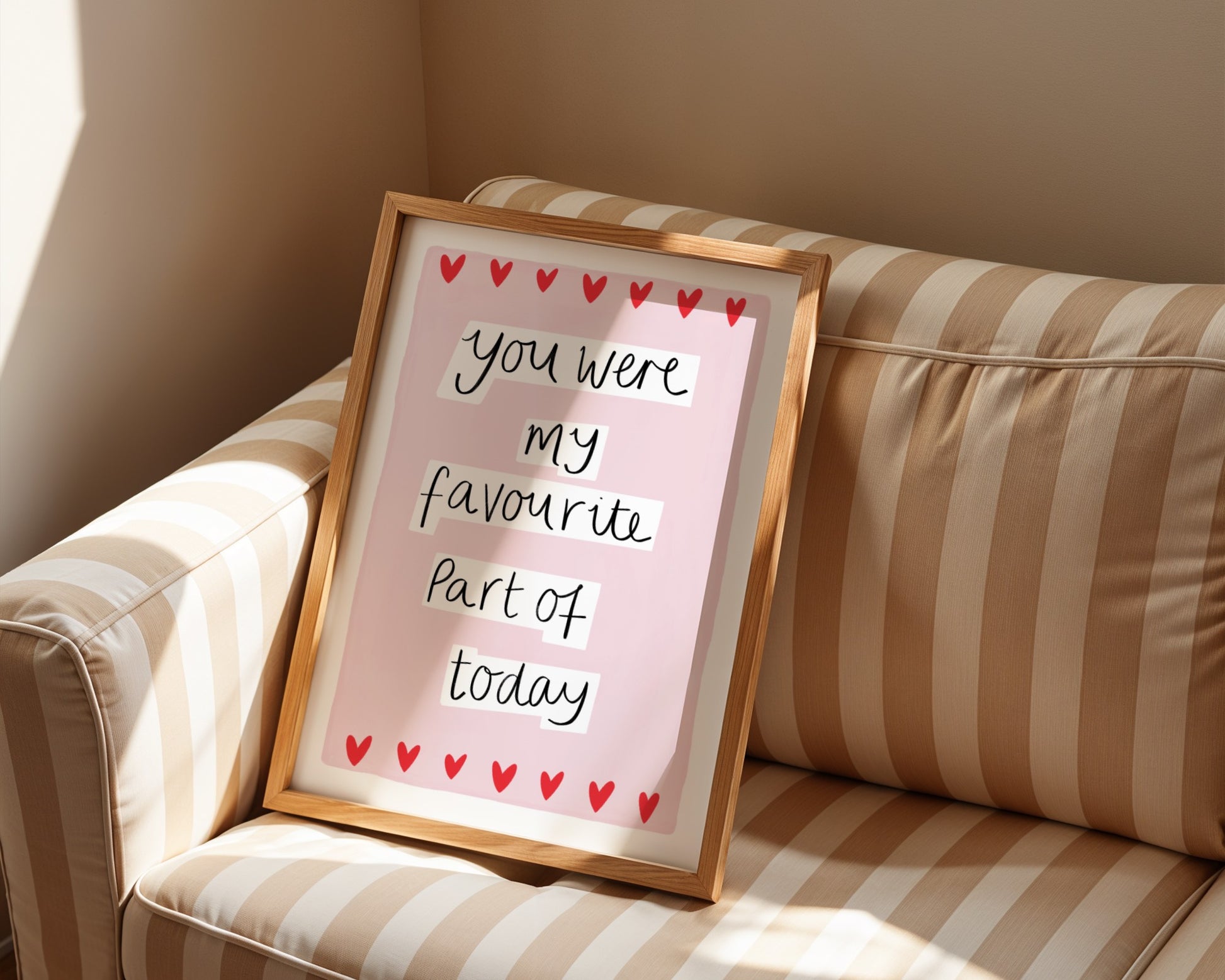 Framed quote with hearts on a striped couch