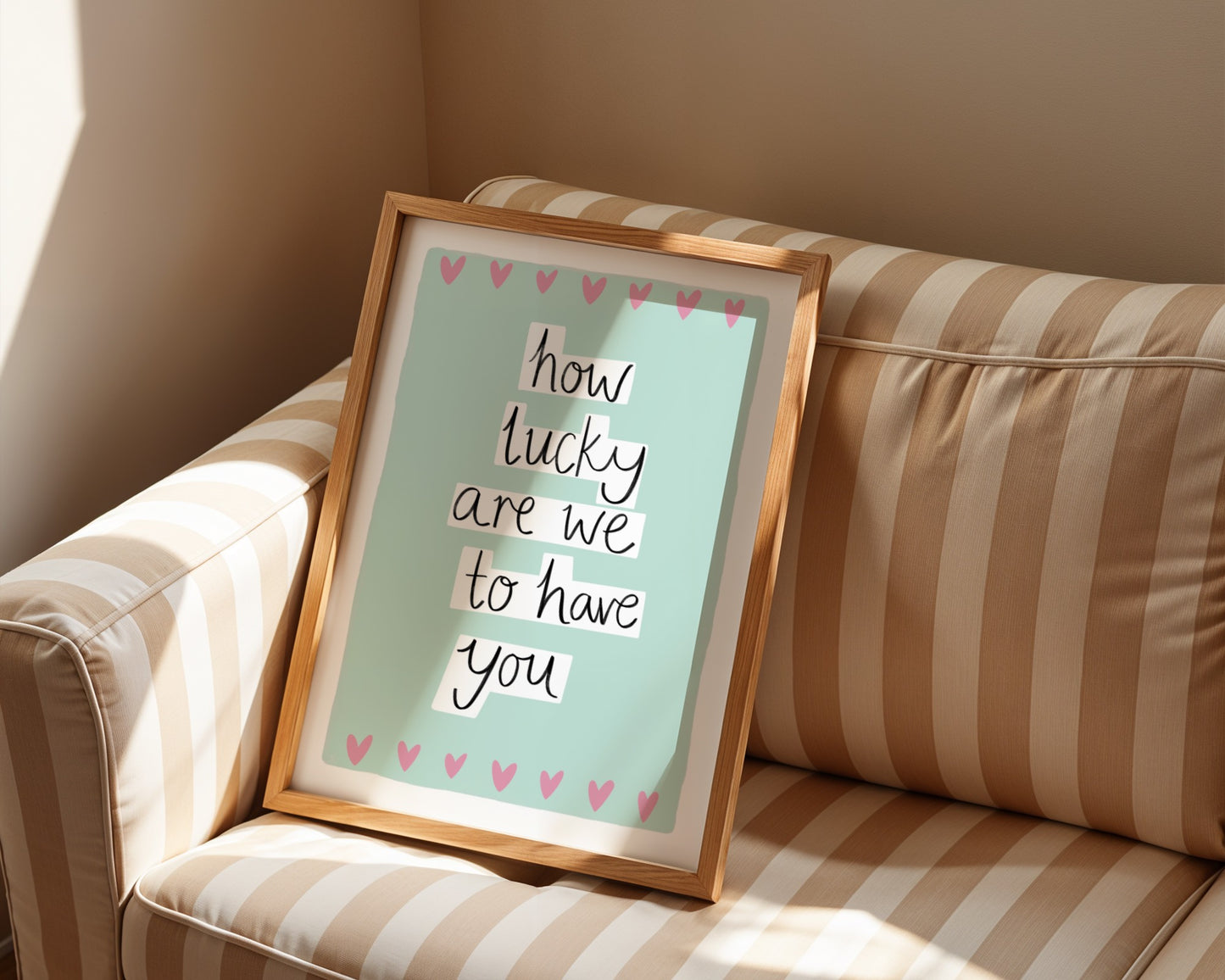 Framed quote 'how lucky are we to have you' on a striped couch