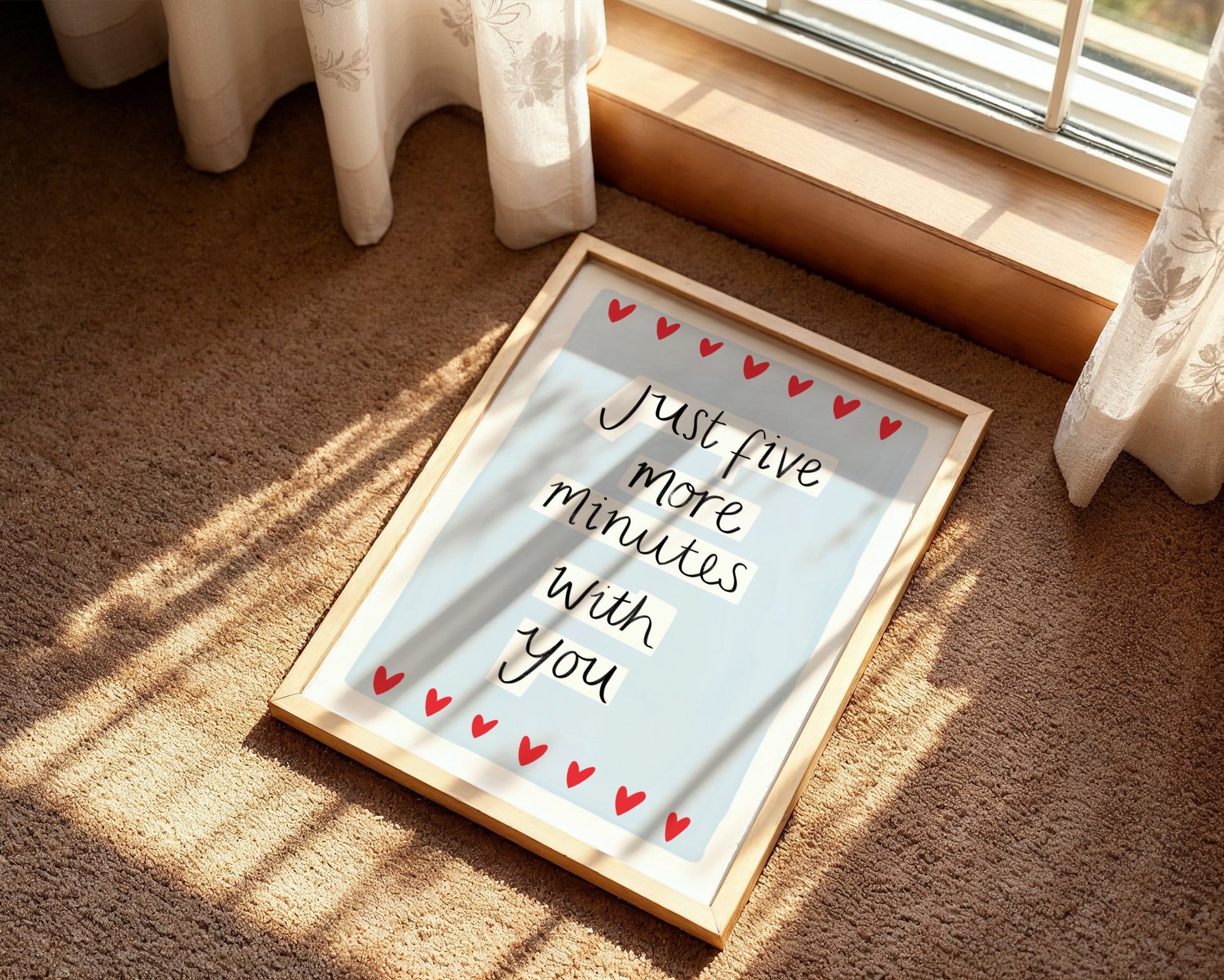Framed picture with 'Just five more minutes with you' text on a carpeted floor.