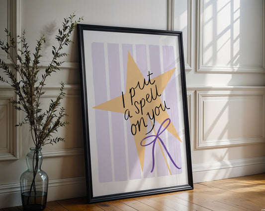 Framed artwork with a yellow star and text on a striped background, placed on a wooden floor.