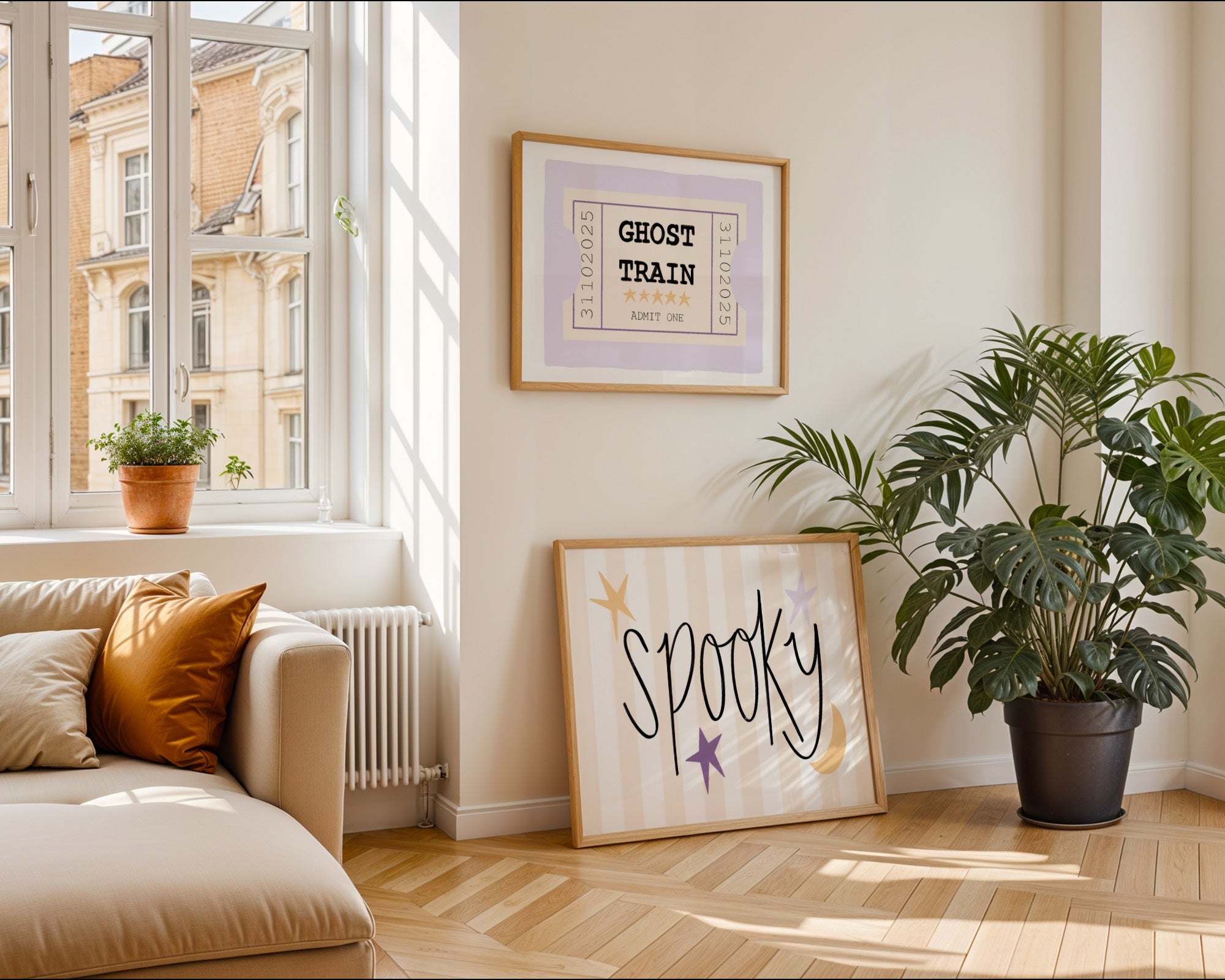 Living room with a couch, plants, and framed pictures on a wall.