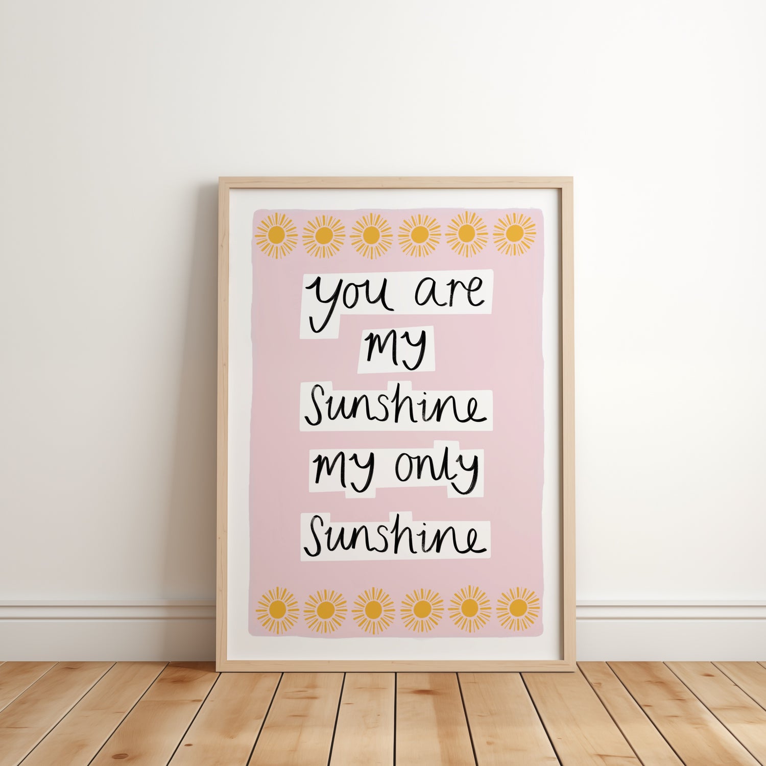 Framed print with 'You are my sunshine, my only sunshine' text on a pink background with sunflower designs.