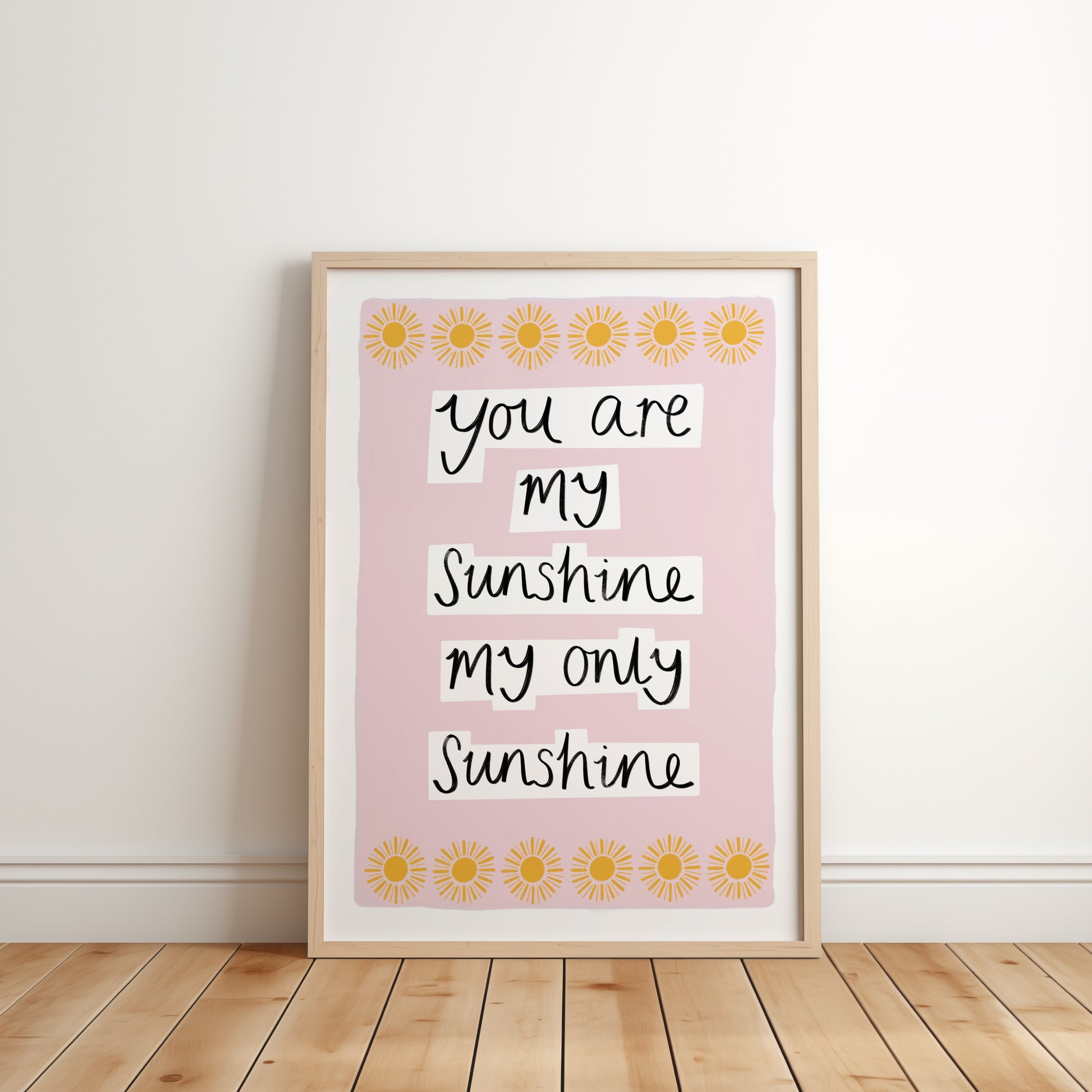 Framed print with 'You are my sunshine, my only sunshine' text on a pink background with sunflower designs.