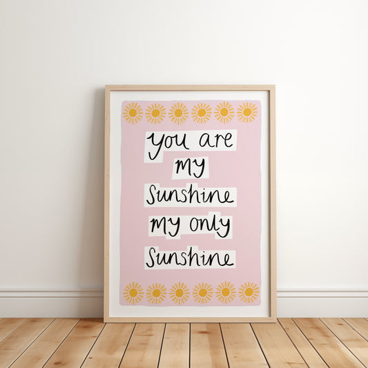Framed print with 'You are my sunshine, my only sunshine' text on a pink background with sunflower designs.