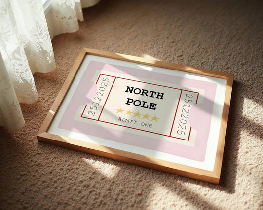 Framed picture of a 'North Pole' ticket on a carpeted floor