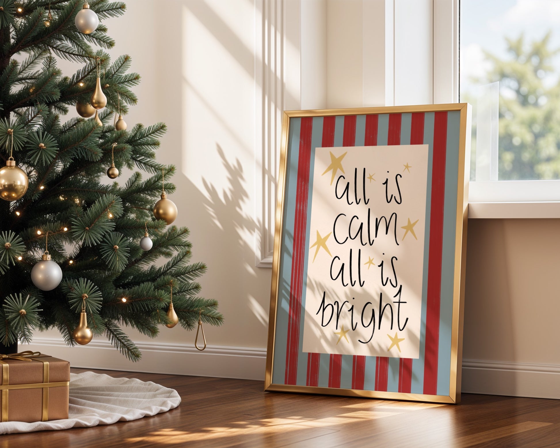 Decorative Christmas tree with ornaments next to a framed print with 'All is calm, all is bright' text.