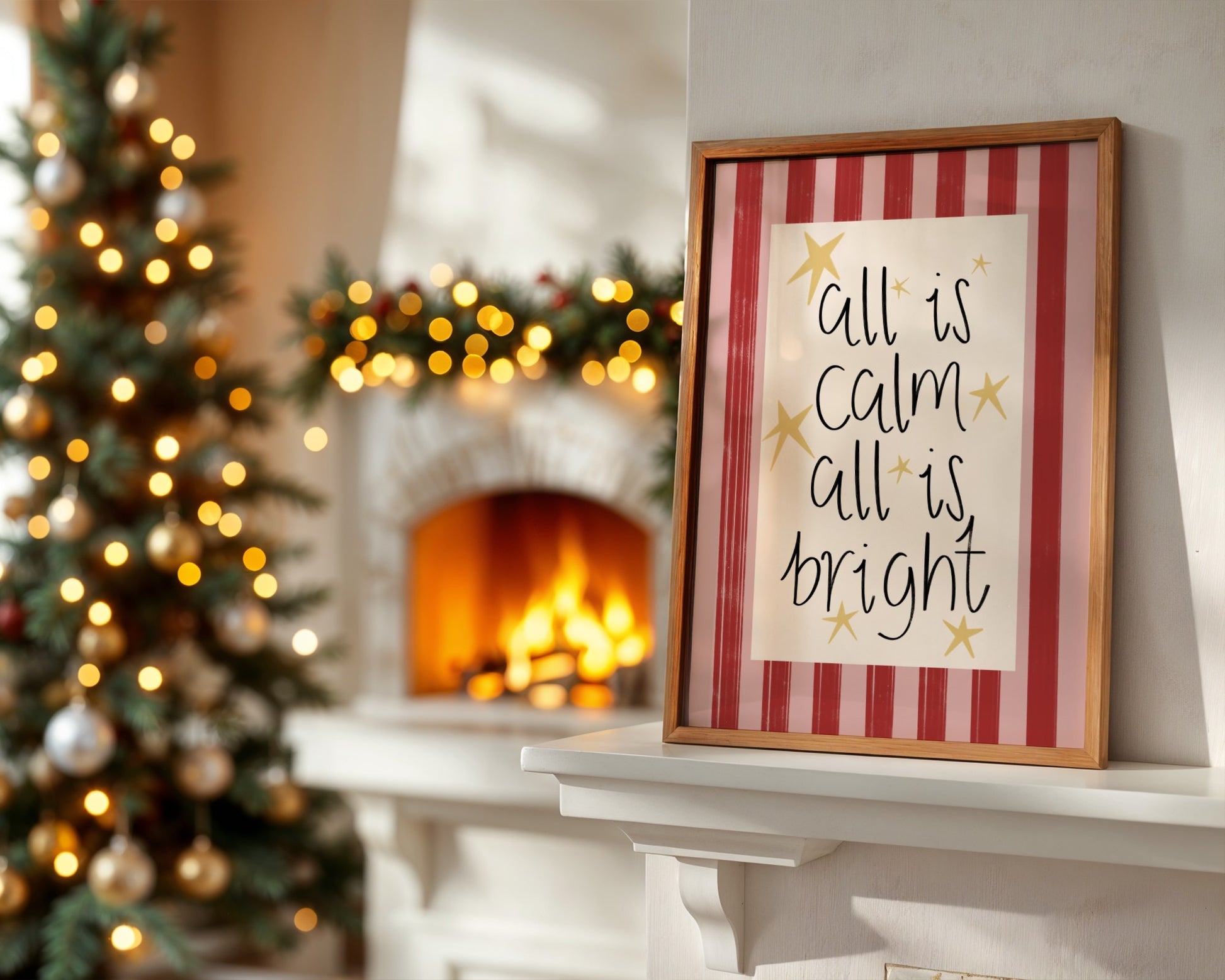 Framed Christmas sign on a mantelpiece with a decorated tree and fireplace in the background.