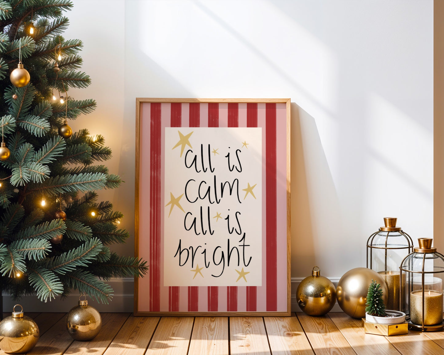 Framed Christmas-themed print with decorative items on a wooden floor.