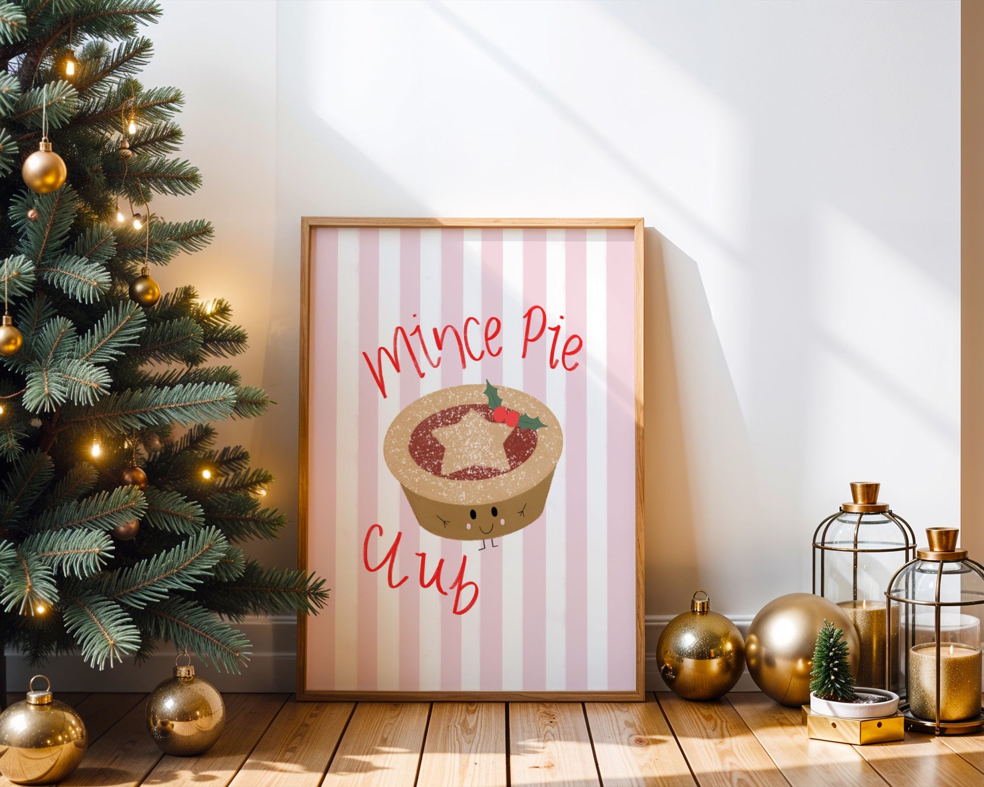 Framed Christmas poster with mince pie design next to a decorated Christmas tree.