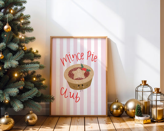 Framed Christmas poster with mince pie design next to a decorated Christmas tree.