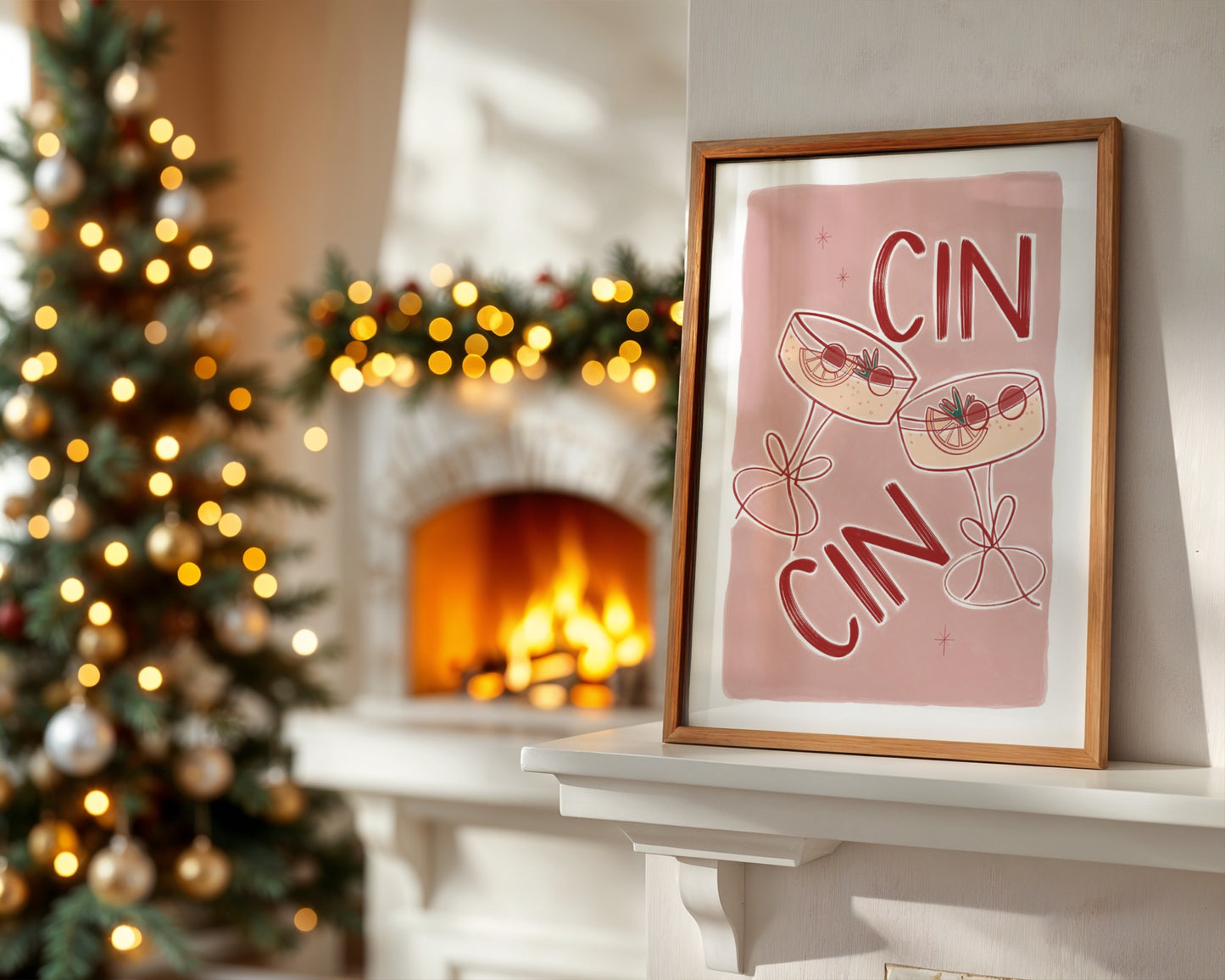 Framed artwork with 'CIN CIN' text on a mantelpiece with Christmas tree and fireplace in the background