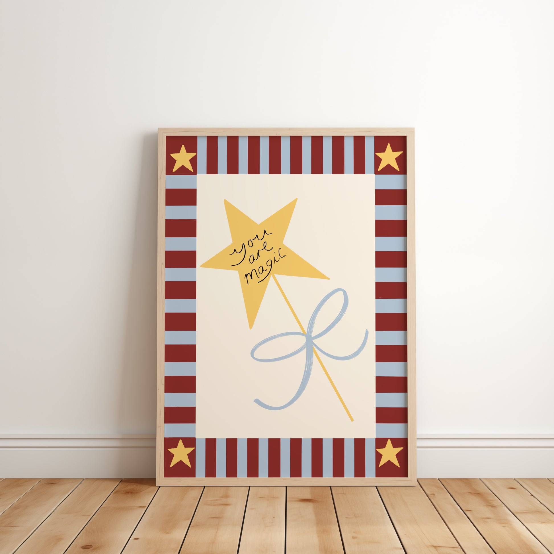 Decorative wall art with a yellow star and text on a striped background, placed on a wooden floor.