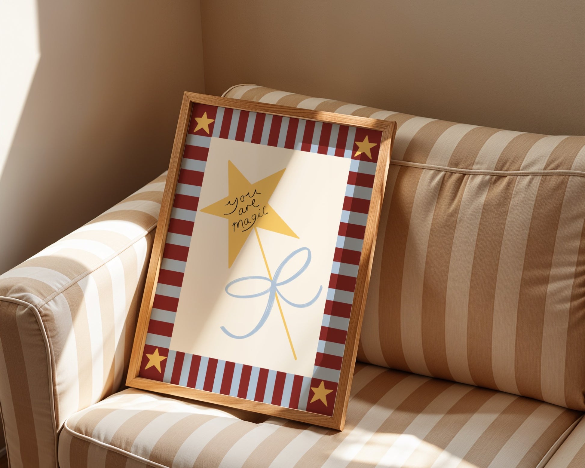 Framed artwork with a star and text on a striped couch