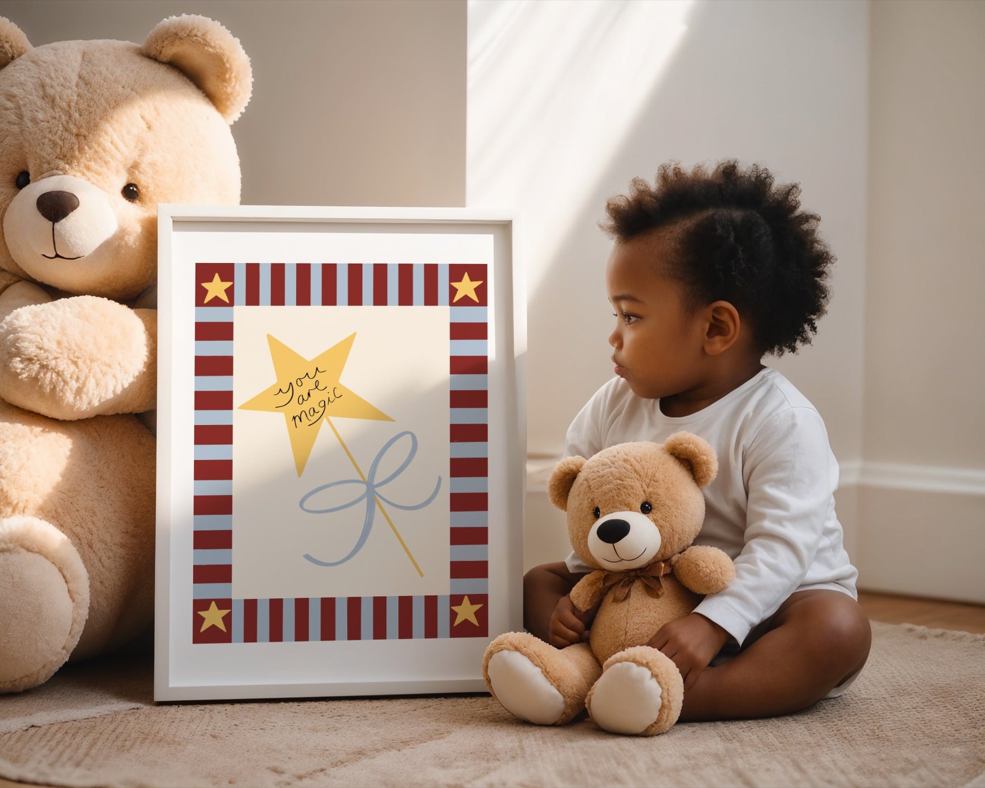 Child sitting on the floor with a teddy bear next to a framed picture of a star and kite.