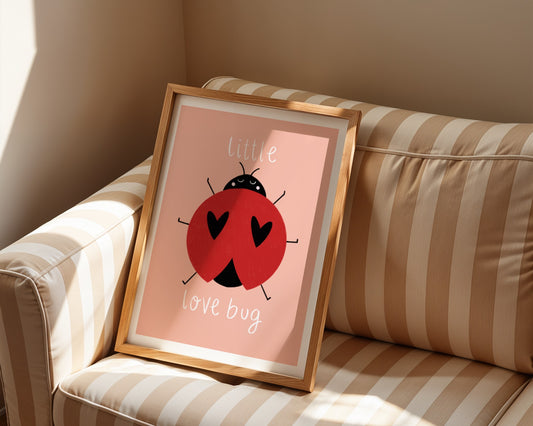 Kids wall art with peach background,  a hand drawn illustration of a ladybird with face and the words “little love bug” In white handwritten text.