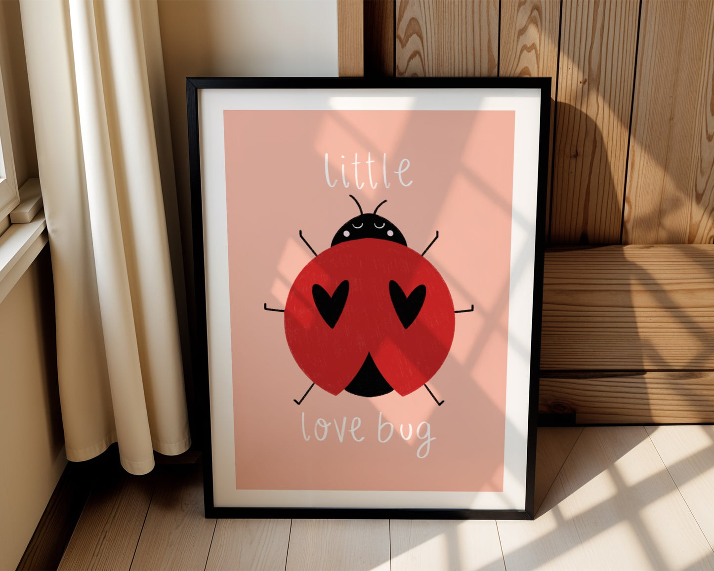 Kids wall art with pink background,  a hand drawn illustration of a ladybird with face and the words “little love bug” In white handwritten text.