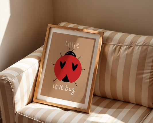 Kids wall art with brown background,  a hand drawn illustration of a ladybird with face and the words “little love bug” In white handwritten text.